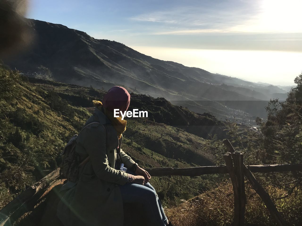 MAN LOOKING AT MOUNTAIN