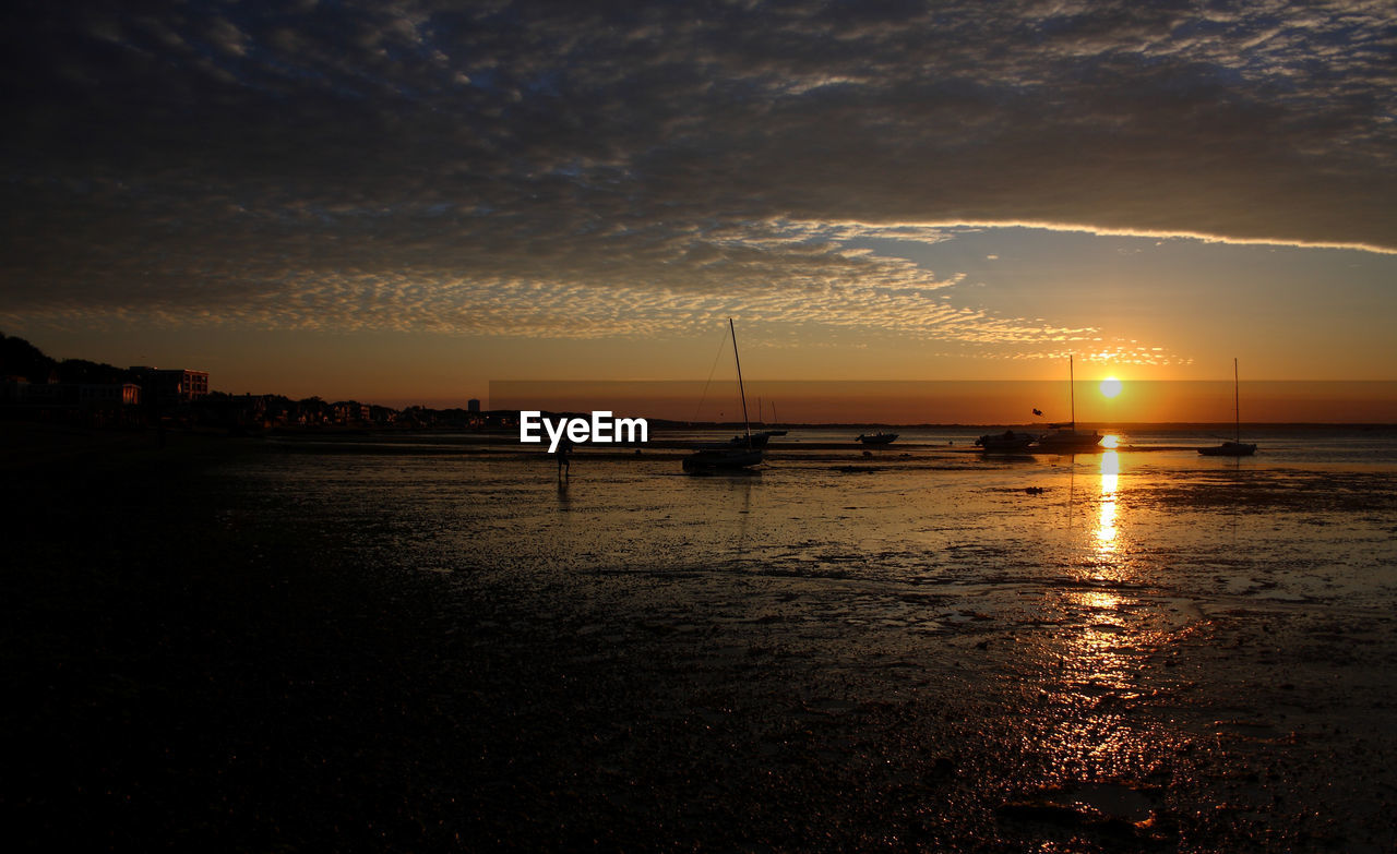 Scenic view of beach against sky during sunset