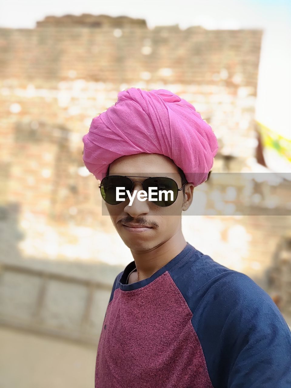 Portrait of man wearing pink turban while standing outdoors