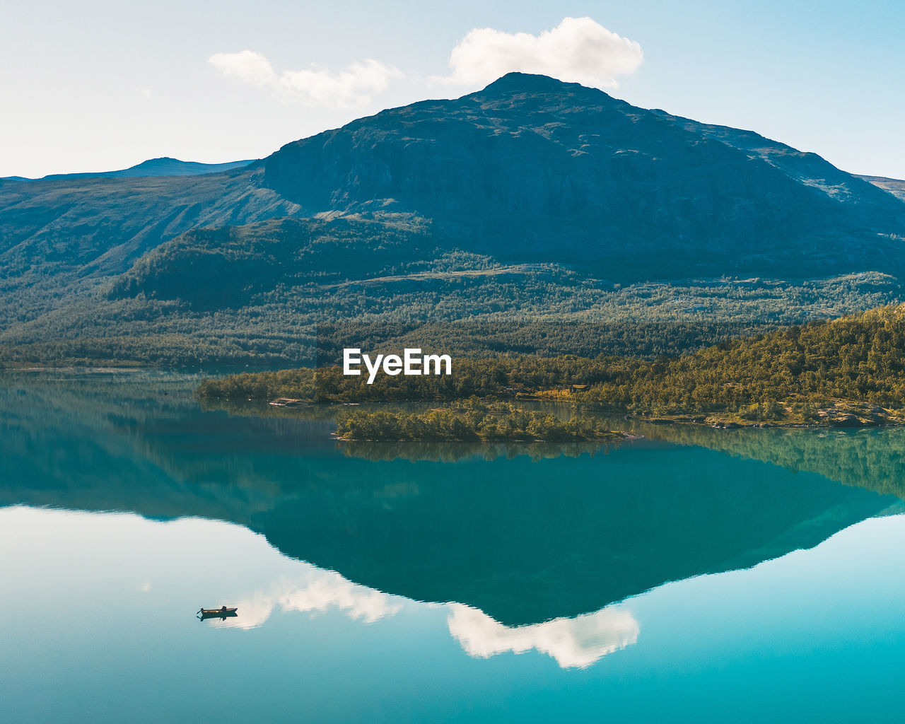 View of lake by mountain against sky