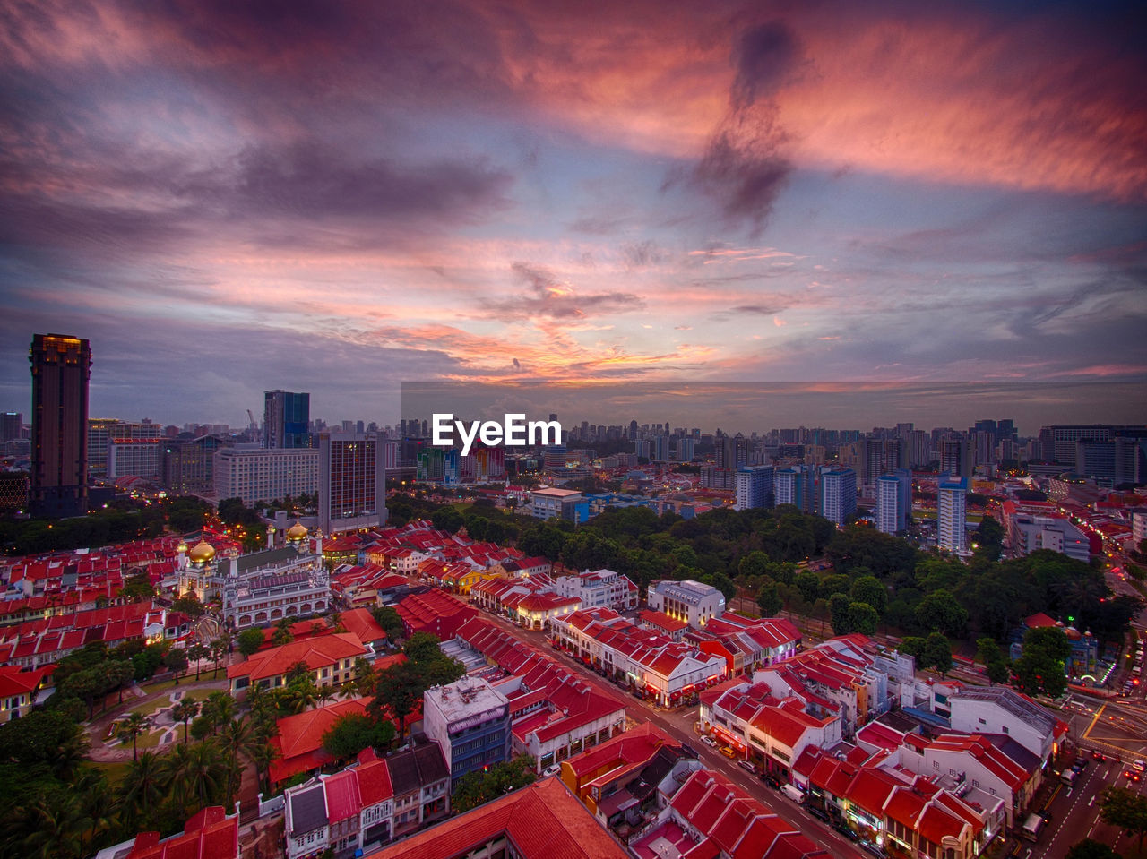 Aerial view of cityscape against sky during sunset