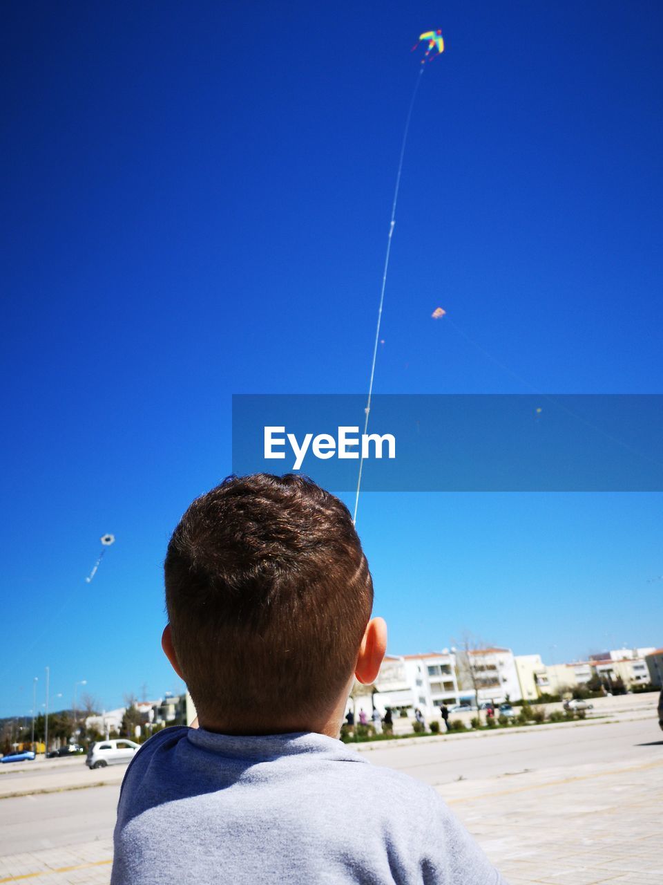 Rear view of a boy against sky
