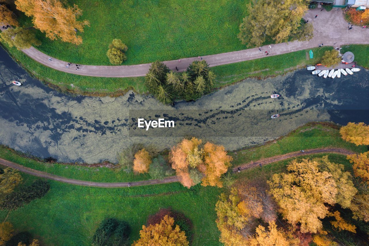 High angle view of trees and river with boats during autumn