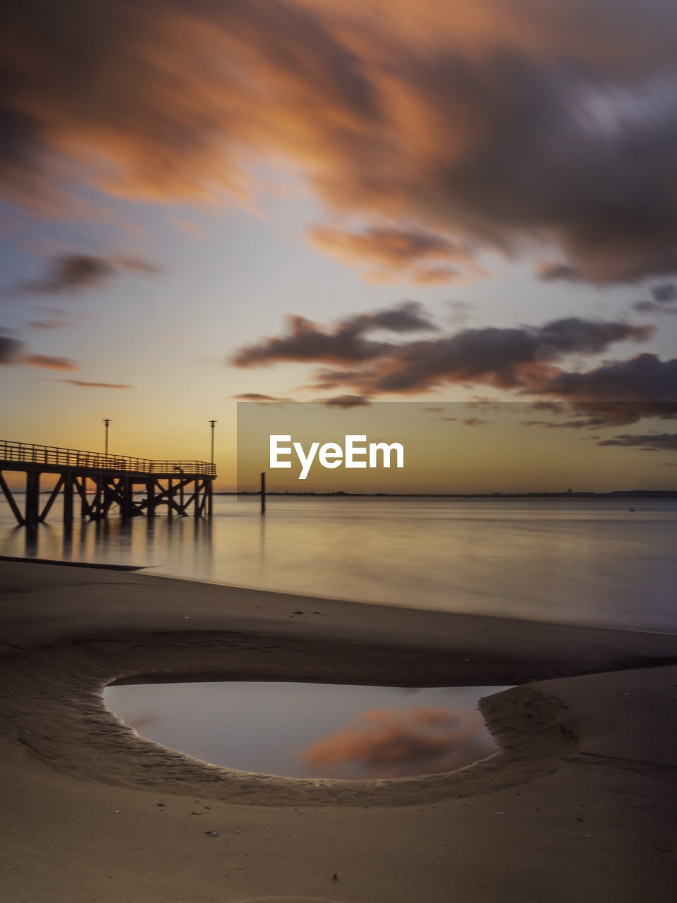 Scenic view of beach against sky during sunset