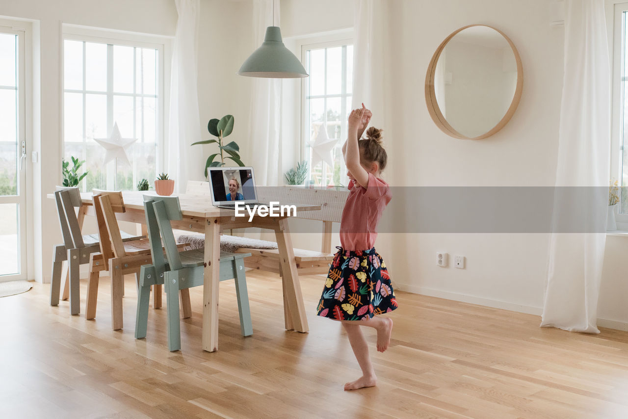 Girl dancing on a video call with a nurse working in a hospital