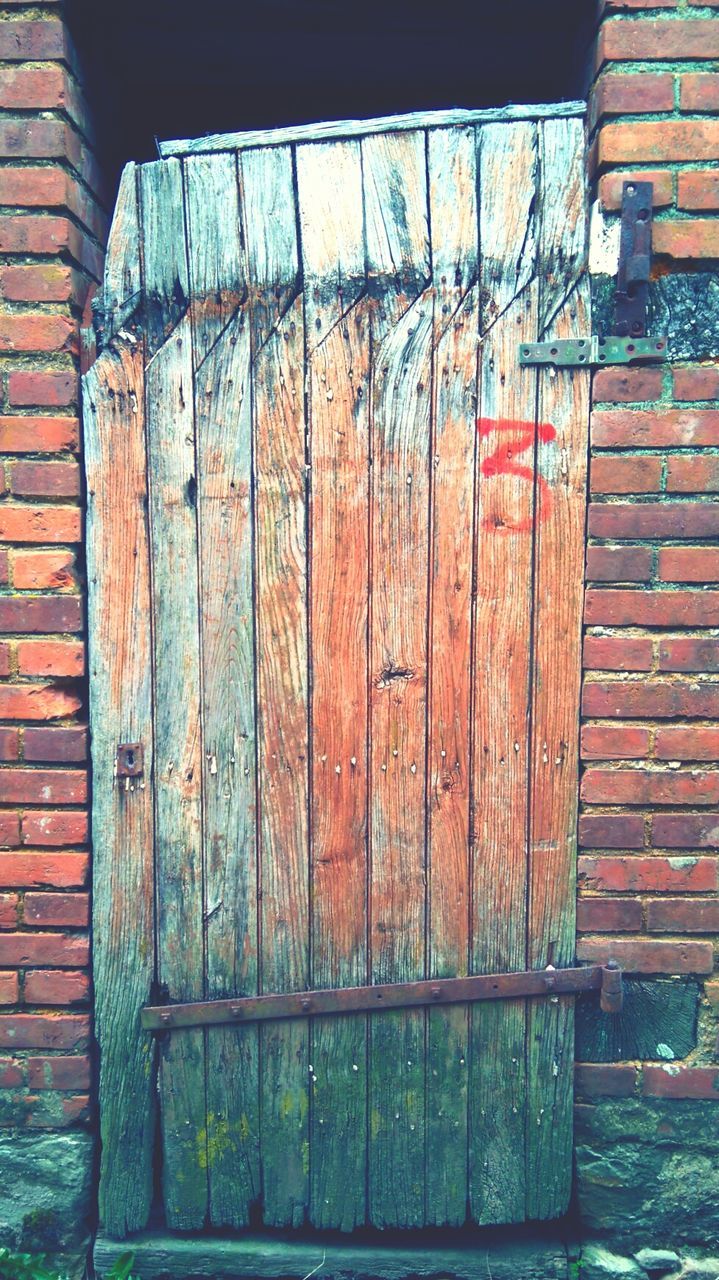 CLOSED WOODEN DOOR OF BUILDING