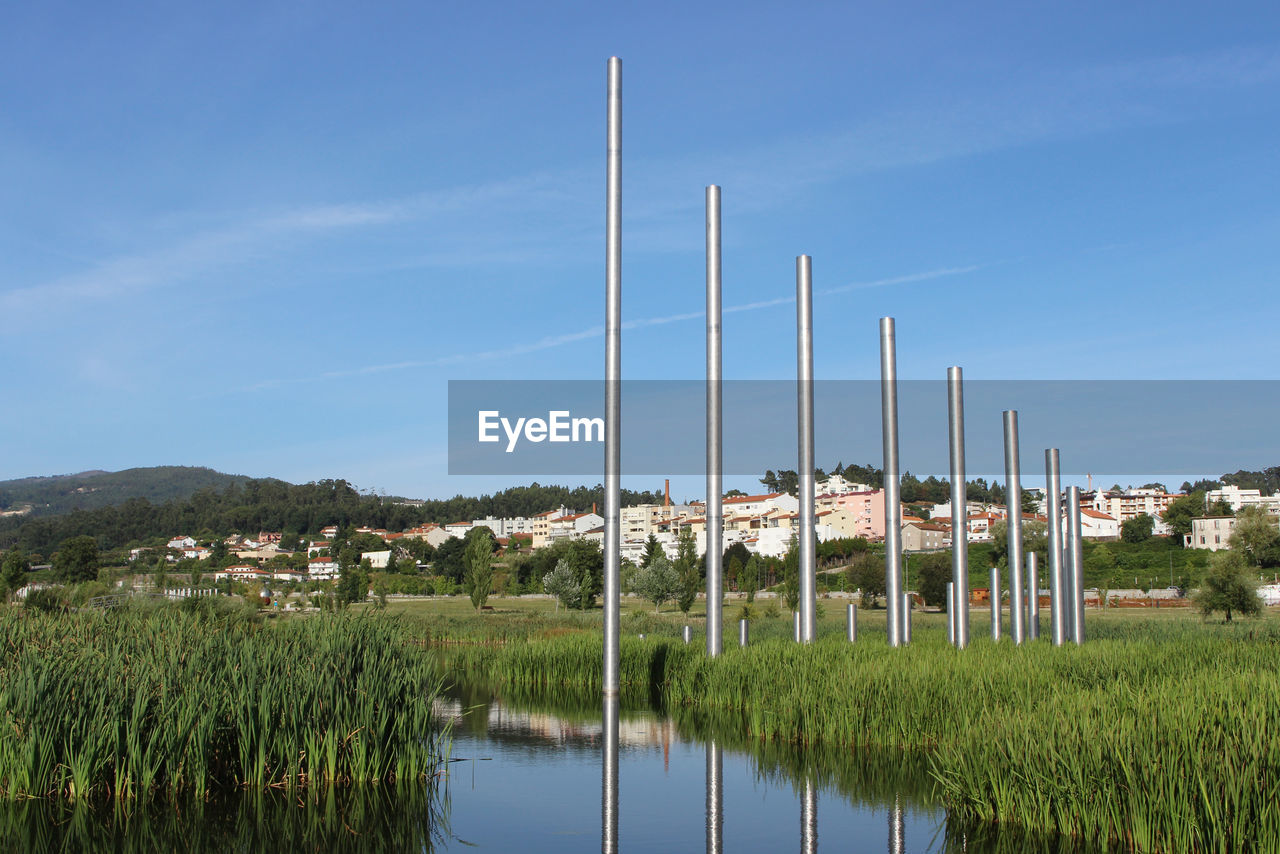 View of poles on field against blue sky