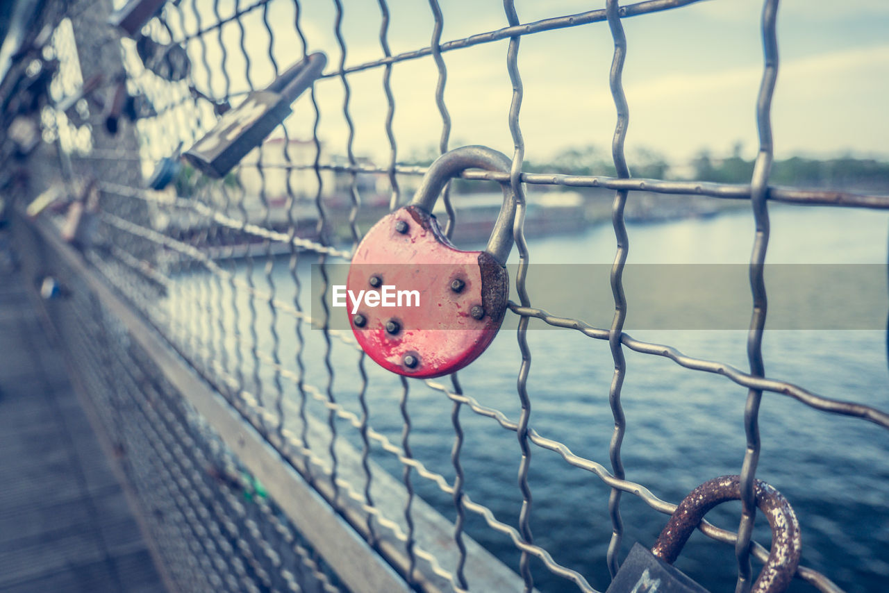 CLOSE-UP OF PADLOCK ON RAILING