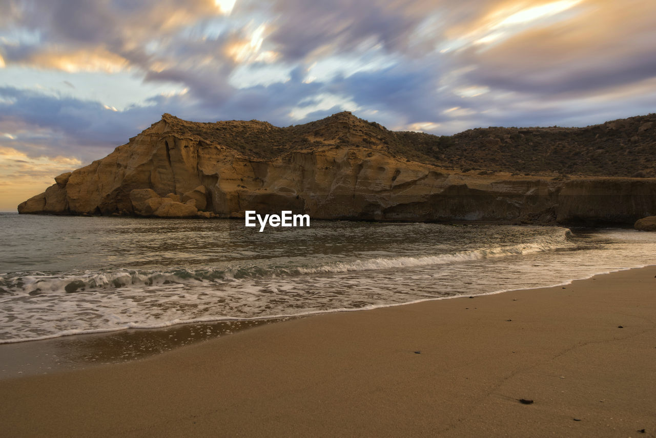 SCENIC VIEW OF BEACH AND MOUNTAINS AGAINST SKY