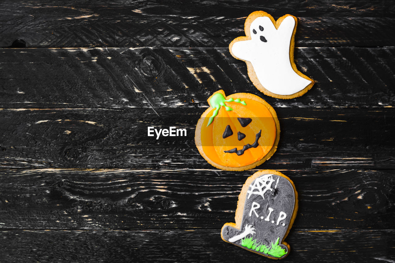 High angle view of various cookies on wooden table during halloween