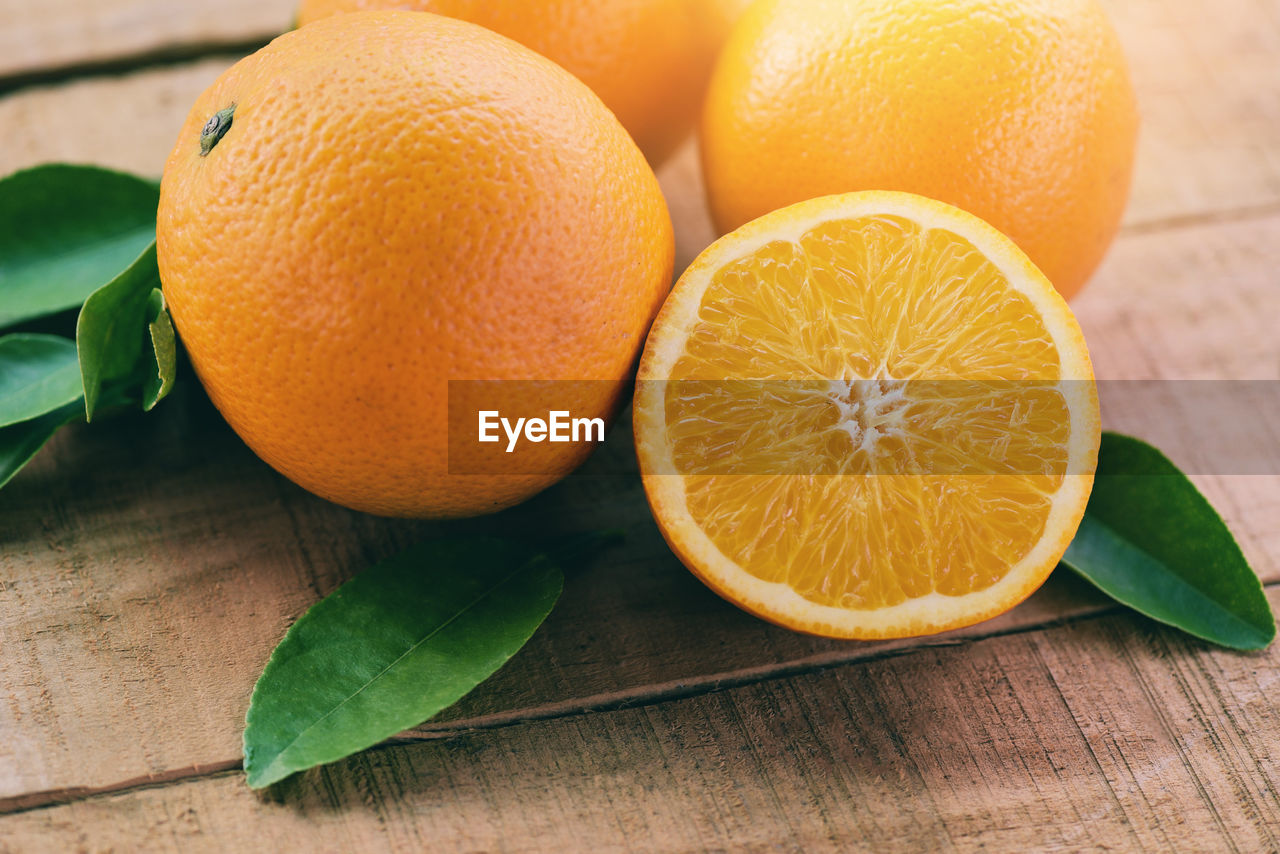 CLOSE-UP OF ORANGE ON TABLE