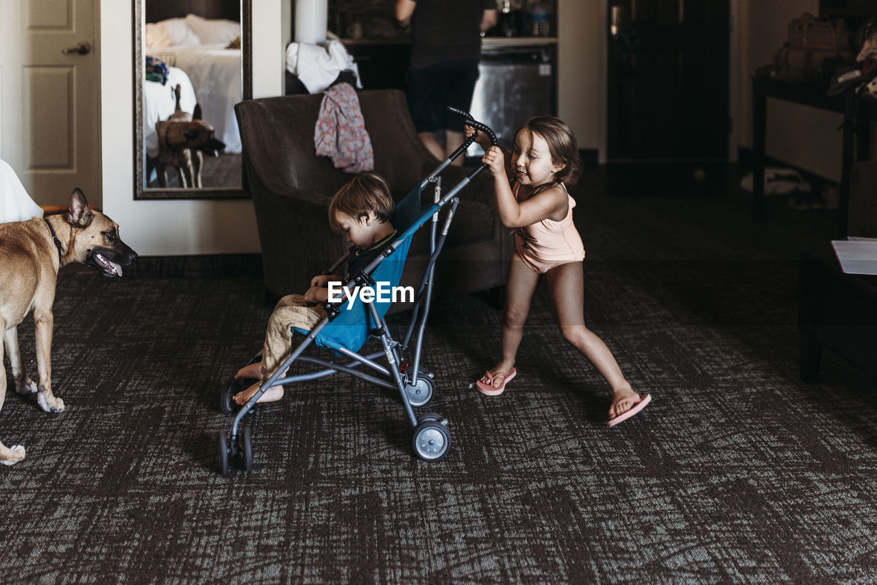 Young siblings playing in stroller in hotel room in palm springs