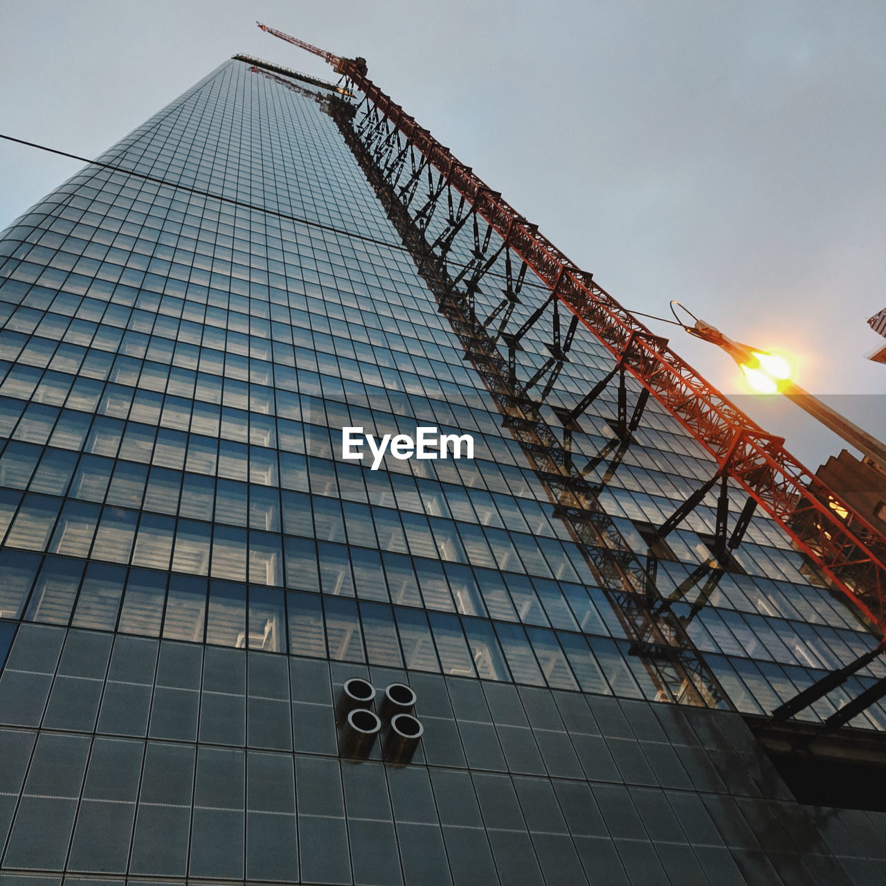 LOW ANGLE VIEW OF METALLIC BUILDING AGAINST SKY