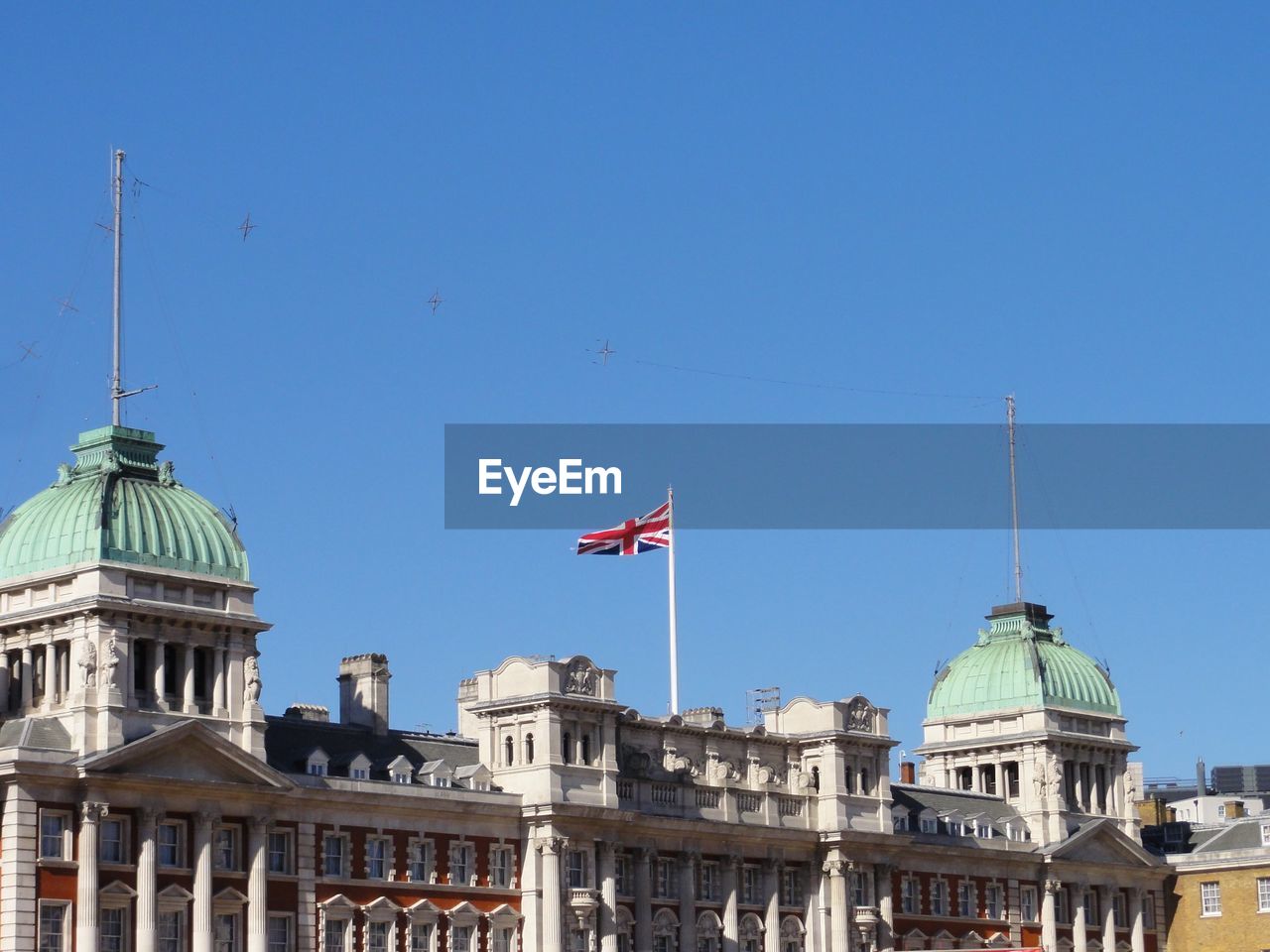 Low angle view of building against clear blue sky