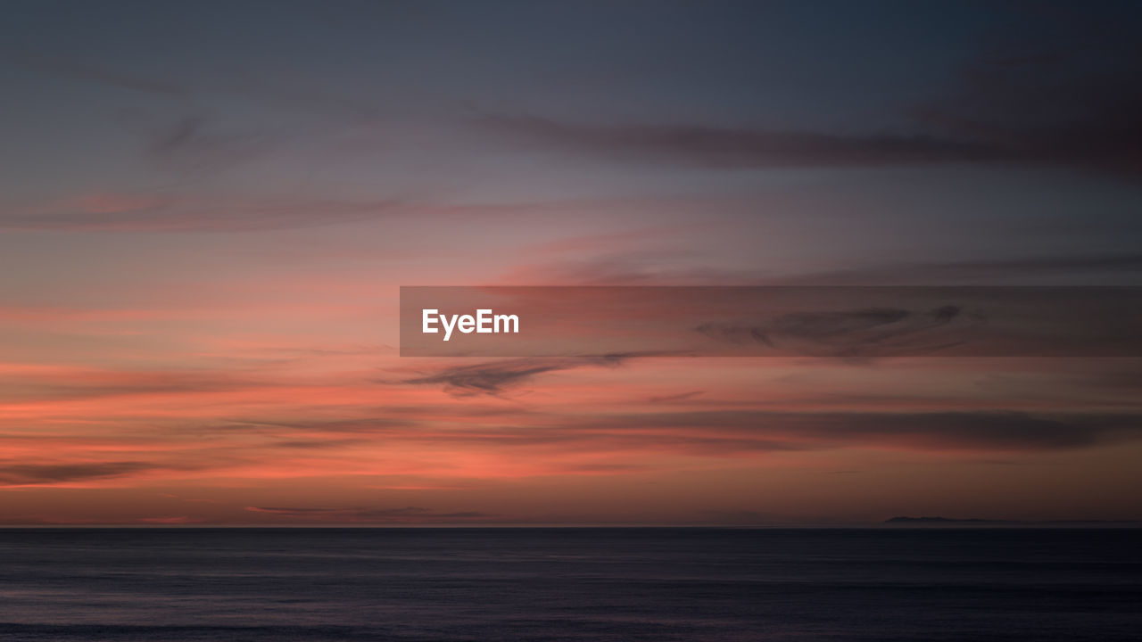 Scenic view of sea against sky at sunset