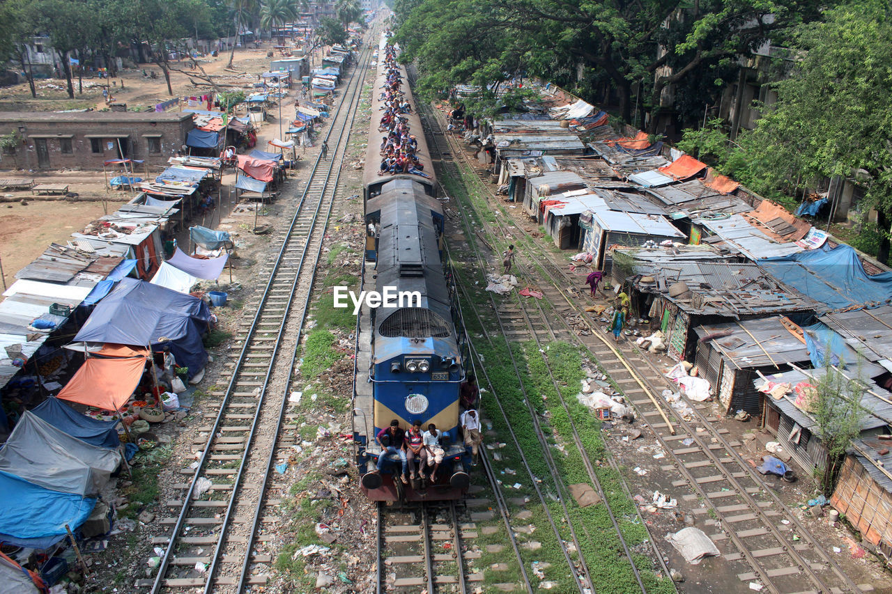 High angle view of railroad tracks amidst trees in city