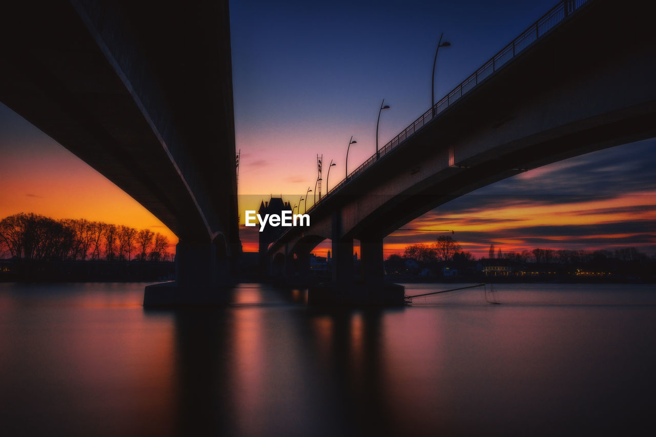 Bridge over river at sunset