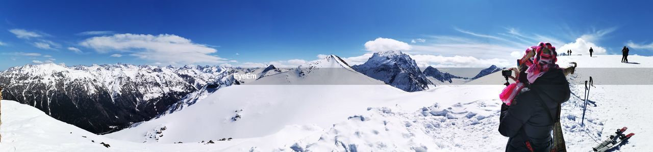 Panoramic view of snowcapped mountains against sky