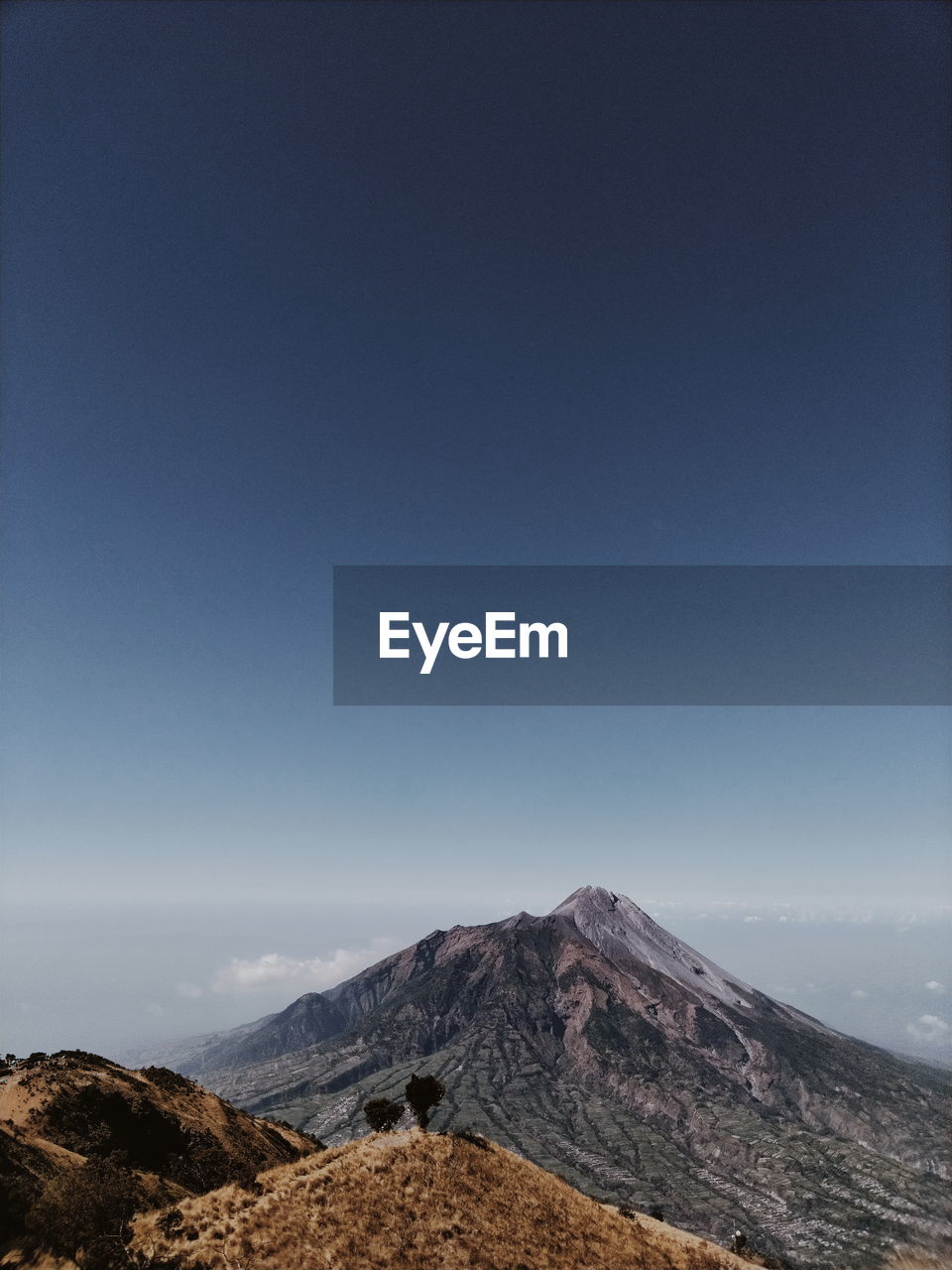 Scenic view of mountains against clear blue sky