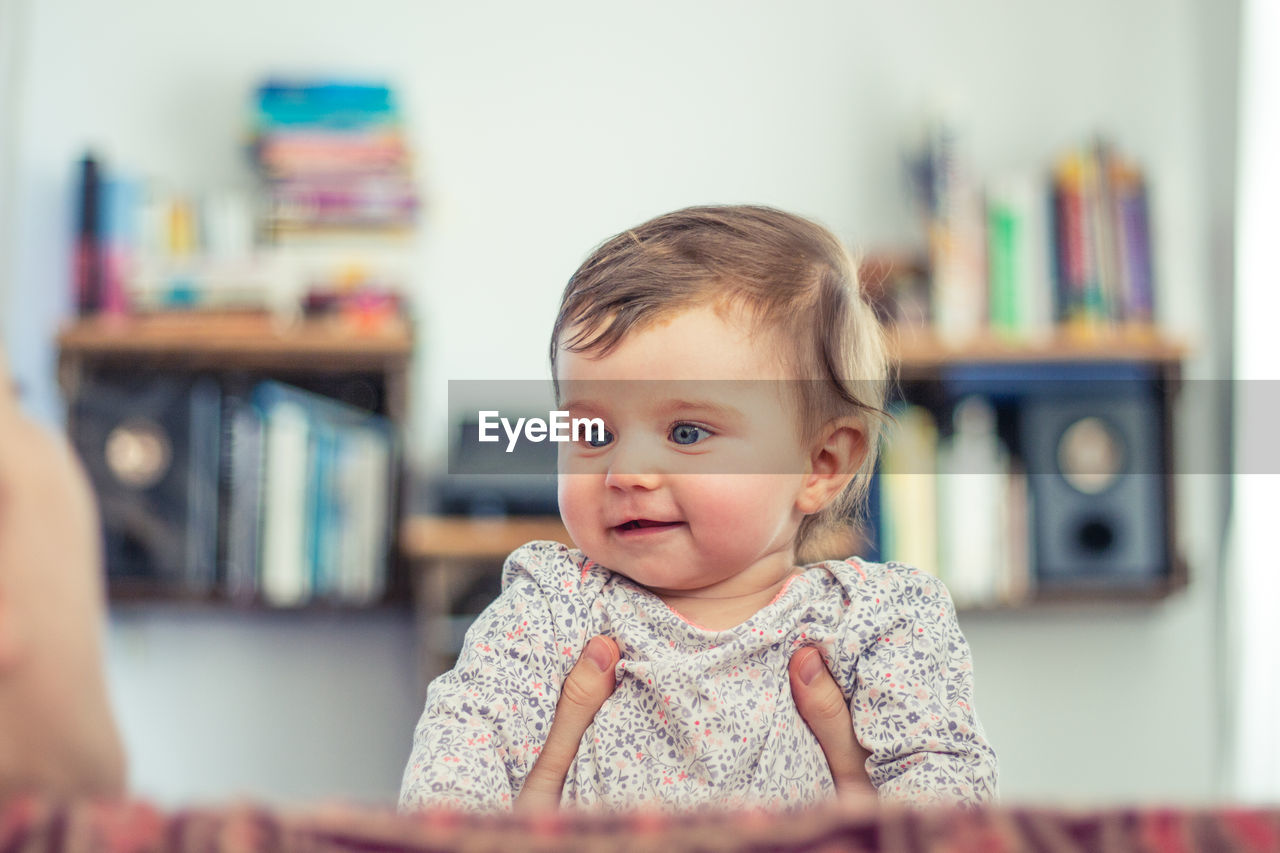 Happy baby toddler at home smiling in living room