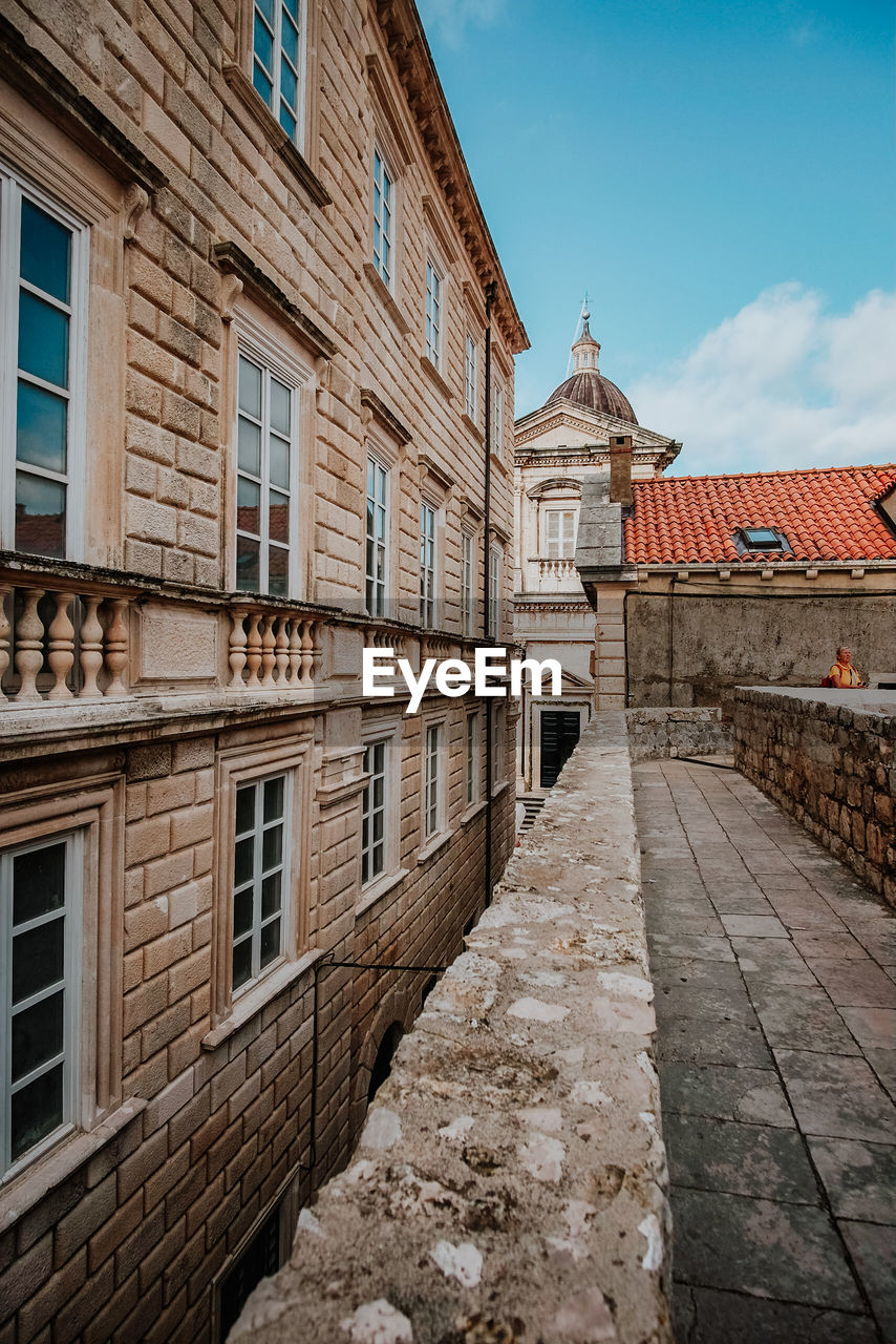 Exterior of old building in town against sky