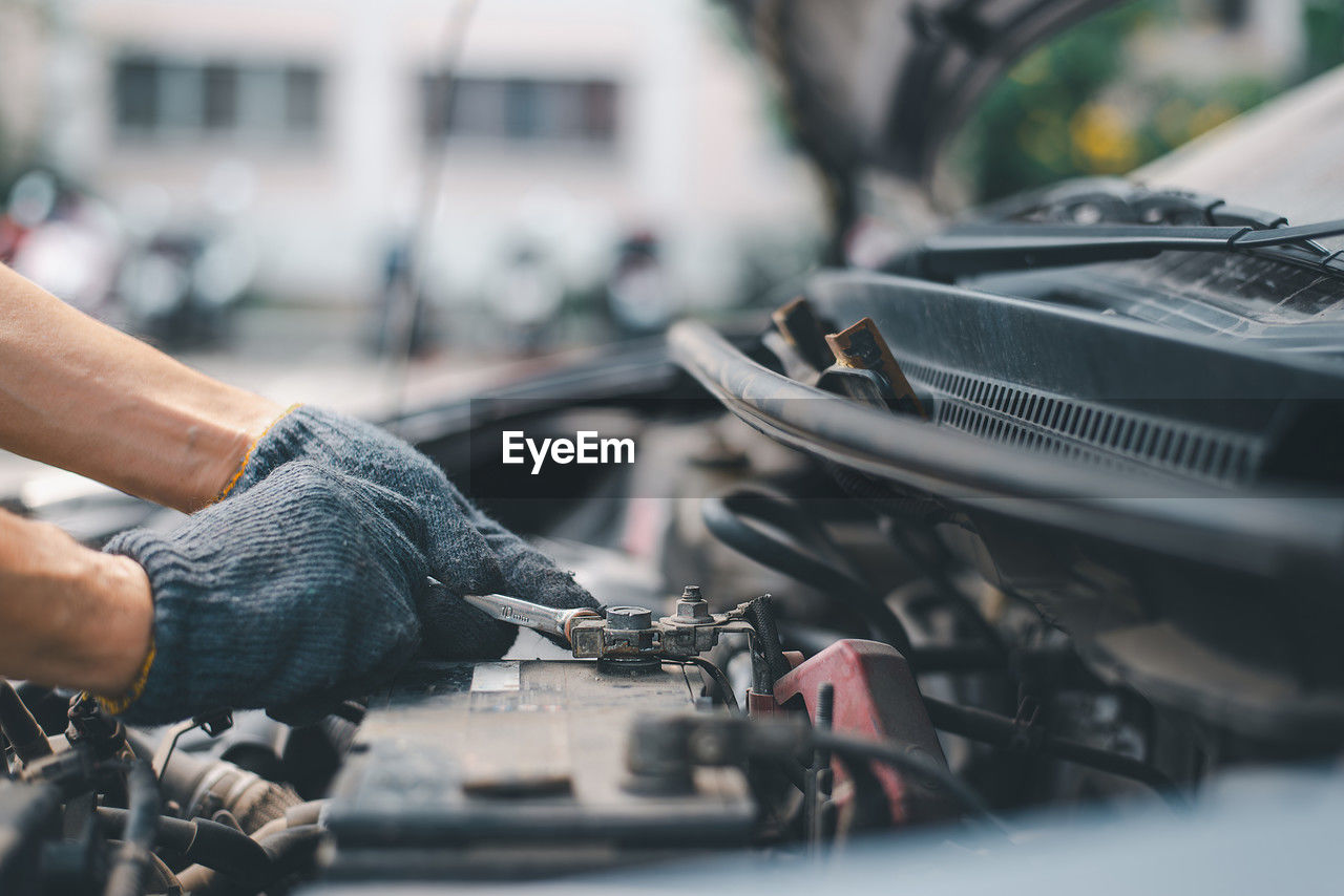 low section of man repairing car