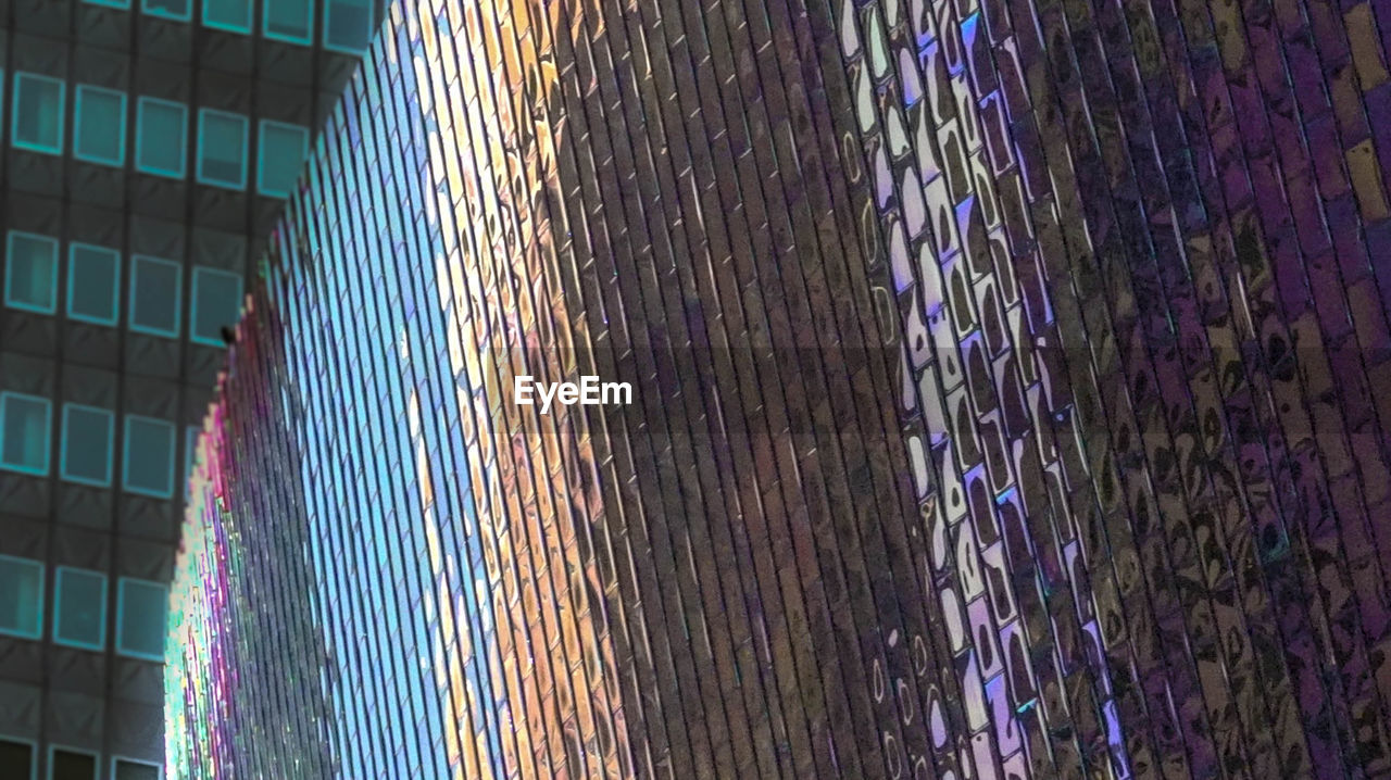LOW ANGLE VIEW OF MULTI COLORED ILLUMINATED BUILDING