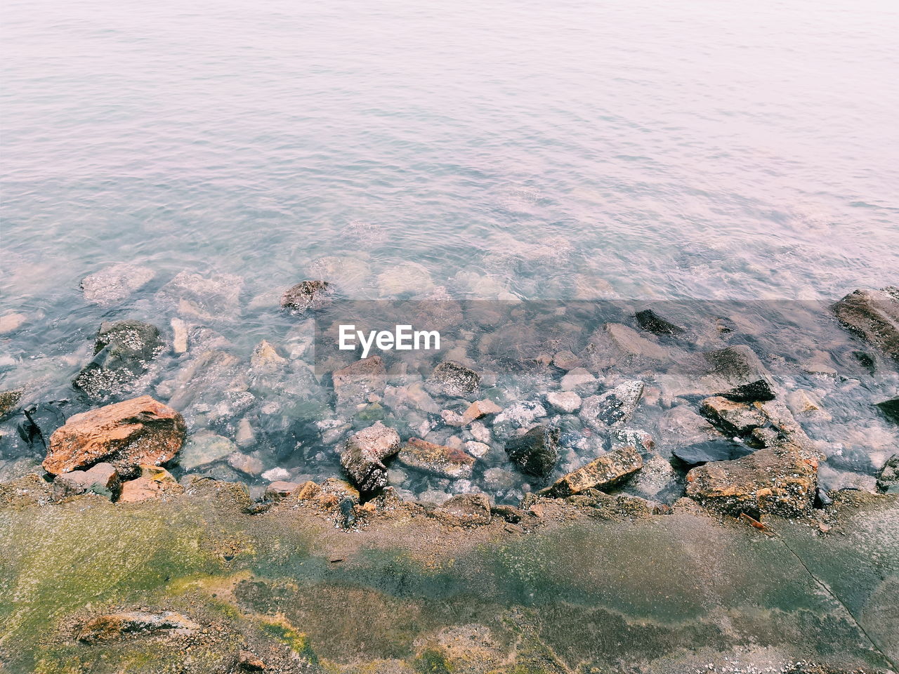 High angle view of rocks on sea shore