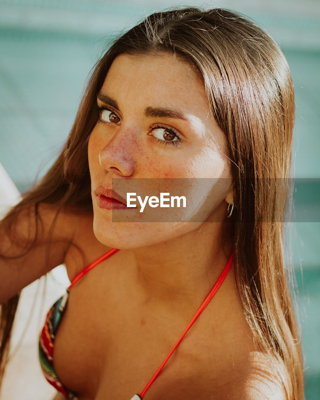 Close-up portrait of young woman in swimming pool