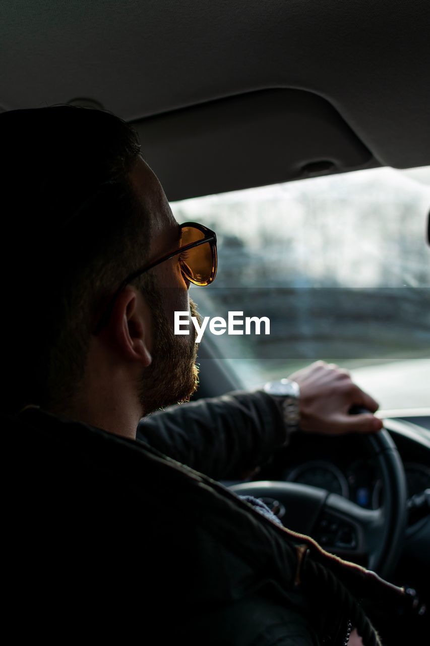 Close-up of man driving car