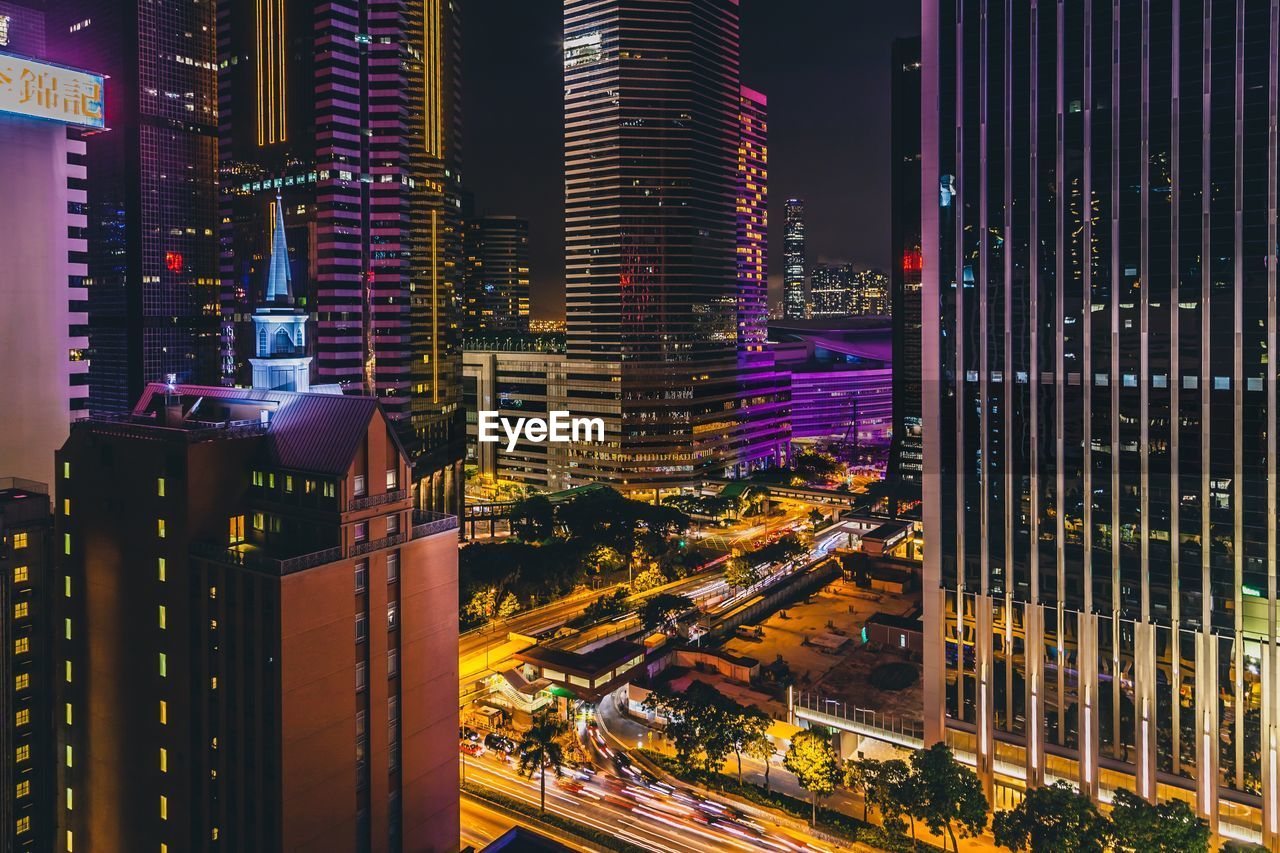 AERIAL VIEW OF ILLUMINATED BUILDINGS IN CITY AT NIGHT