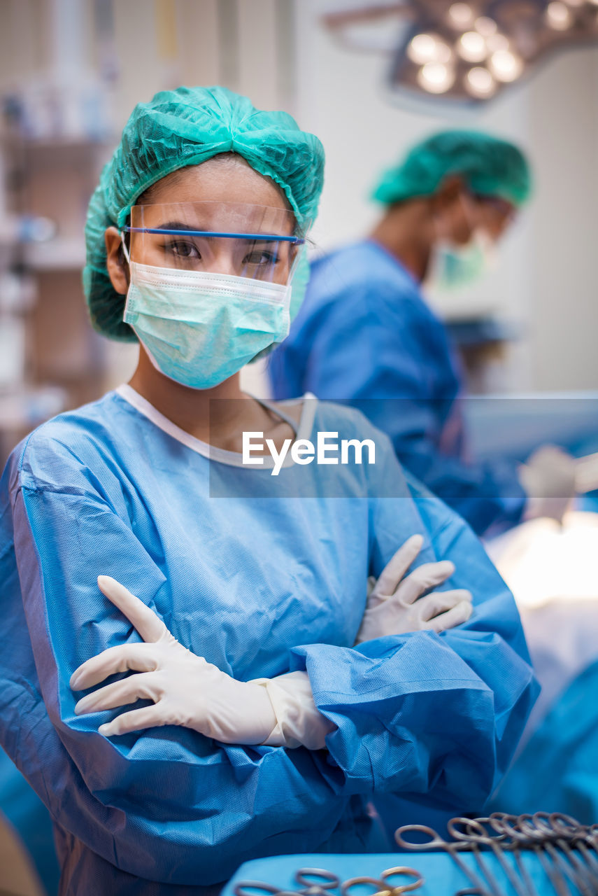 Portrait of doctor with arms crossed standing in operating room 