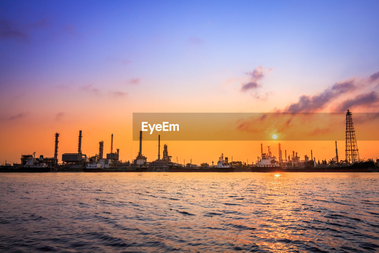 COMMERCIAL DOCK AGAINST SKY DURING SUNSET