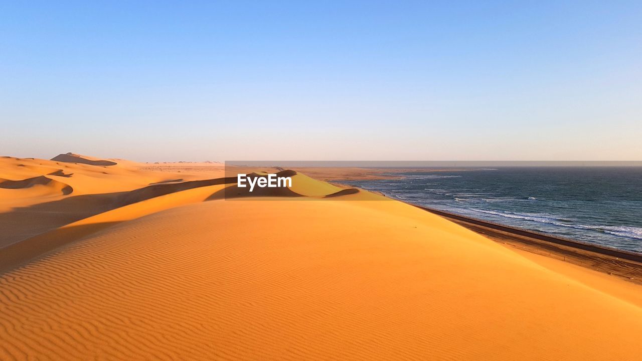 Scenic view of sea against clear sky during sunset