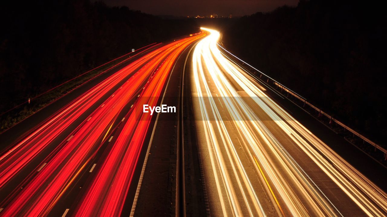 High angle view of light trails on road at night