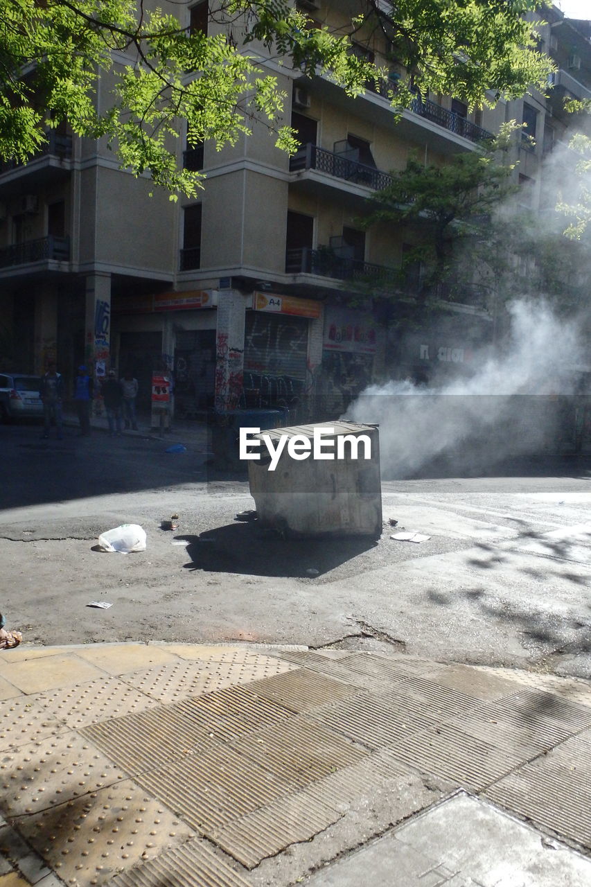 Garbage can on city street during riot