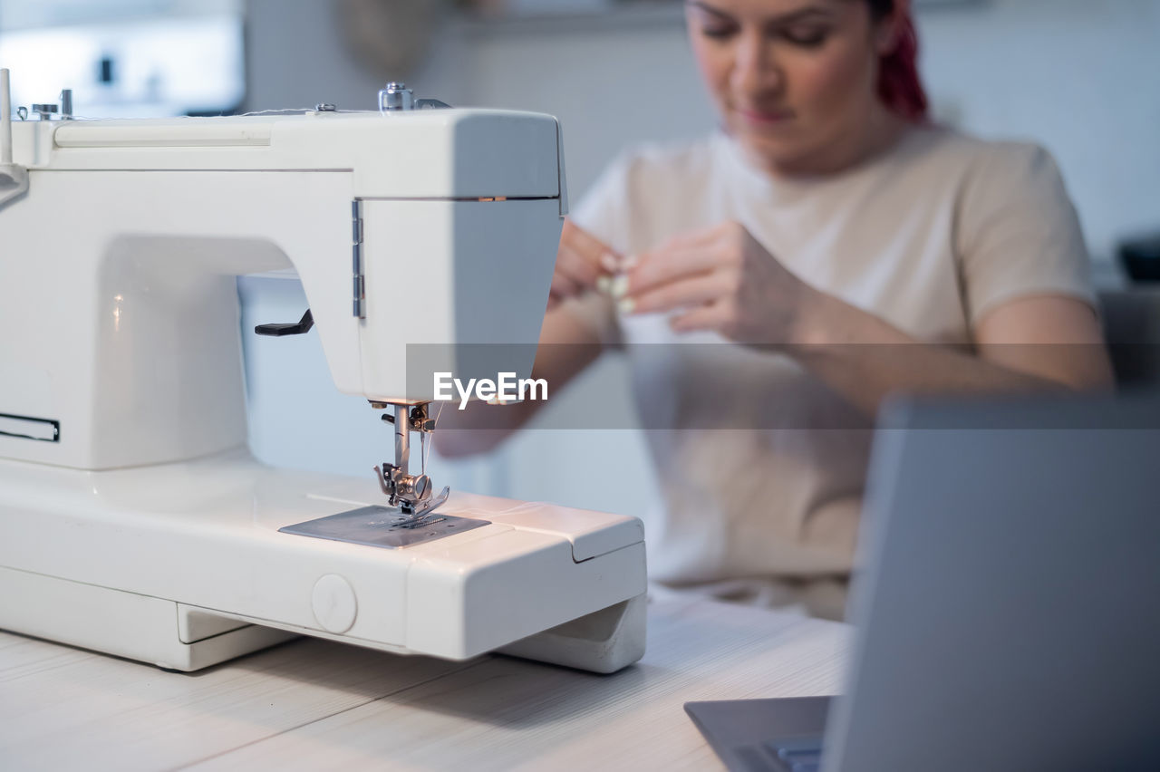 Midsection of woman working on table