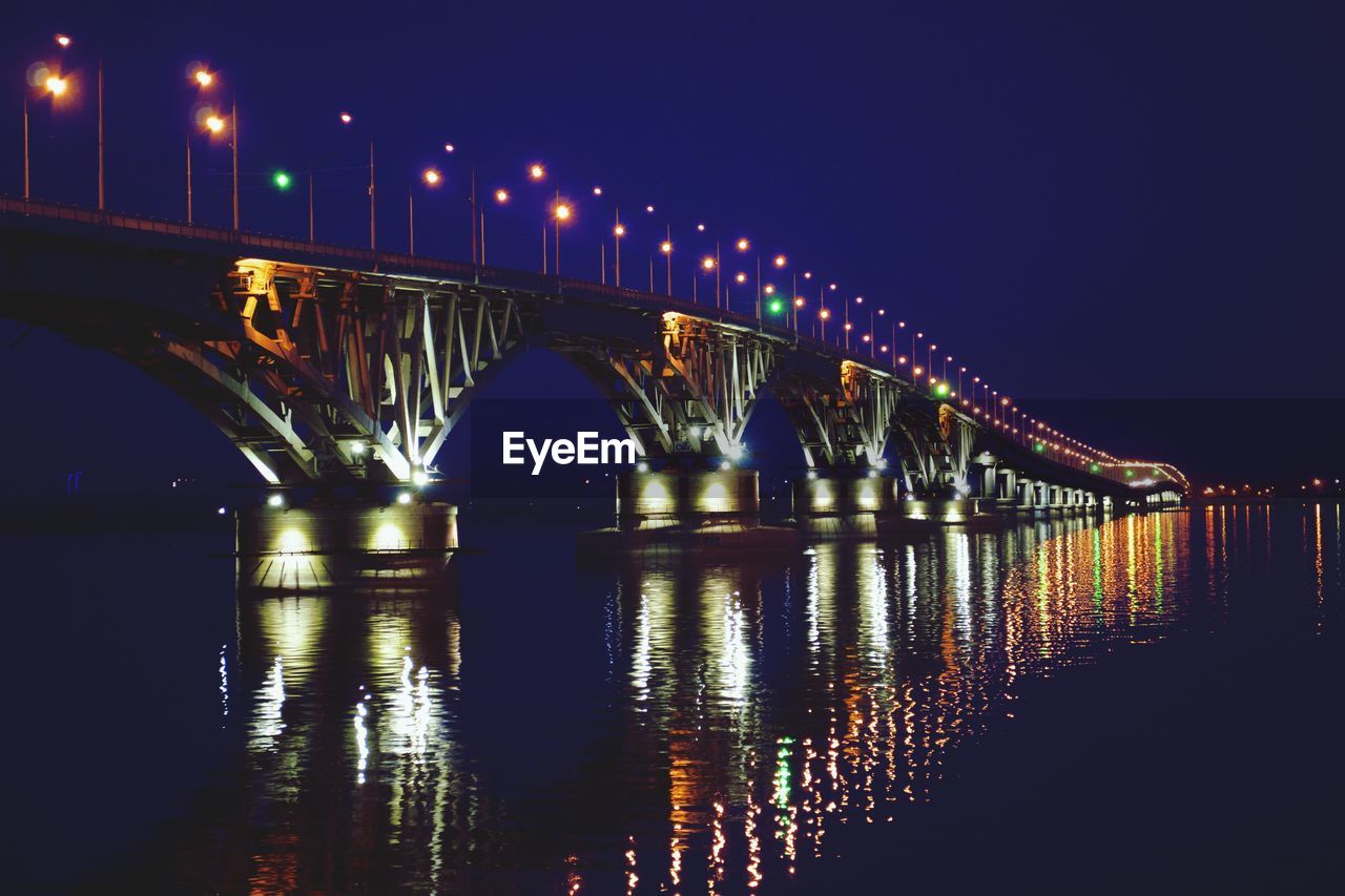 Illuminated saratov bridge on river at night