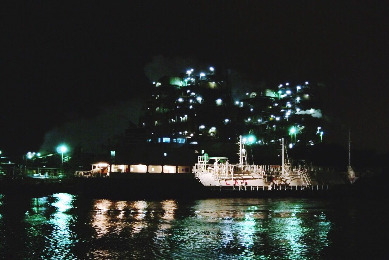 VIEW OF ILLUMINATED CITY AT NIGHT