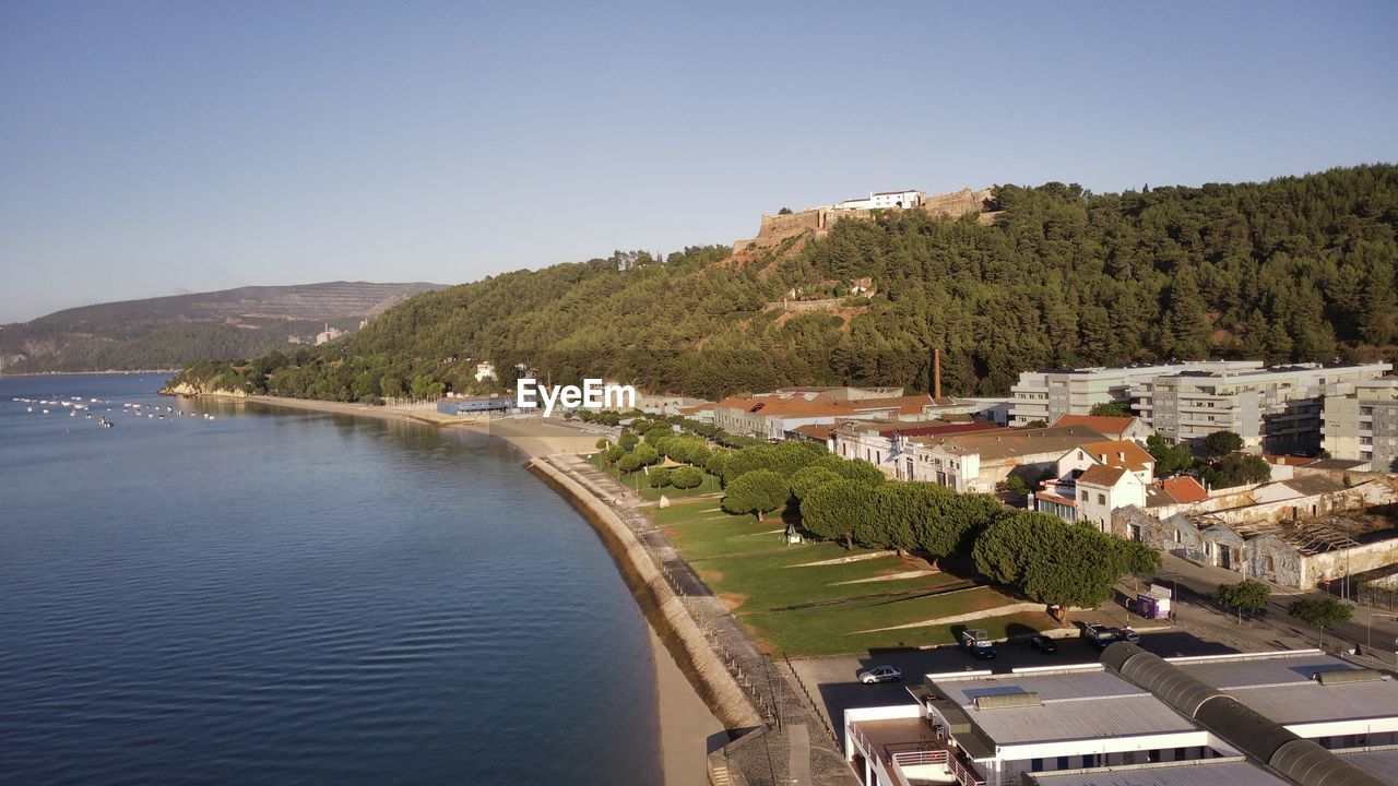 SCENIC VIEW OF RIVER BY MOUNTAINS AGAINST CLEAR SKY