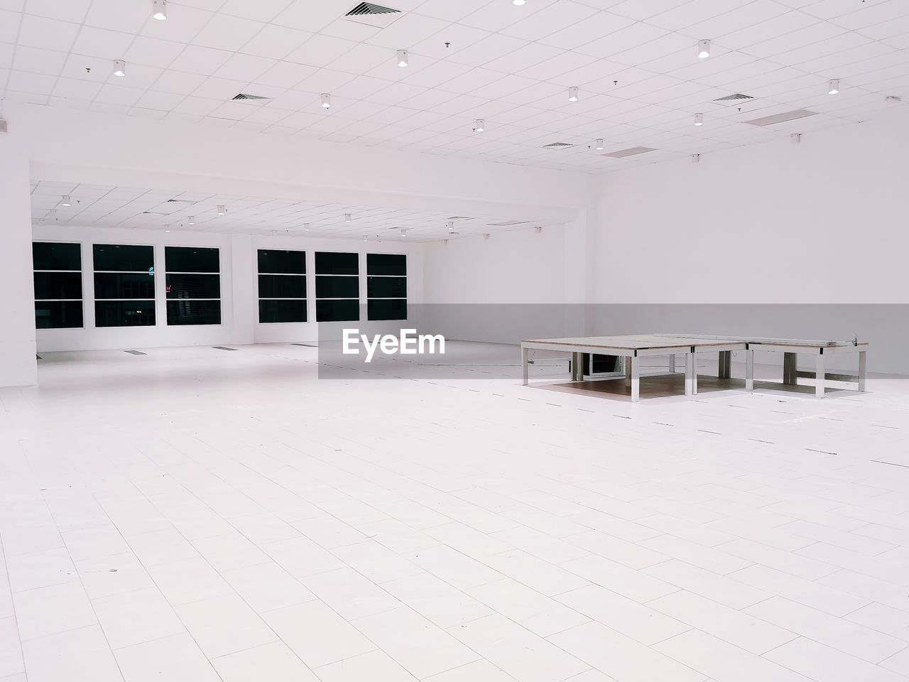 Tables in empty illuminated room