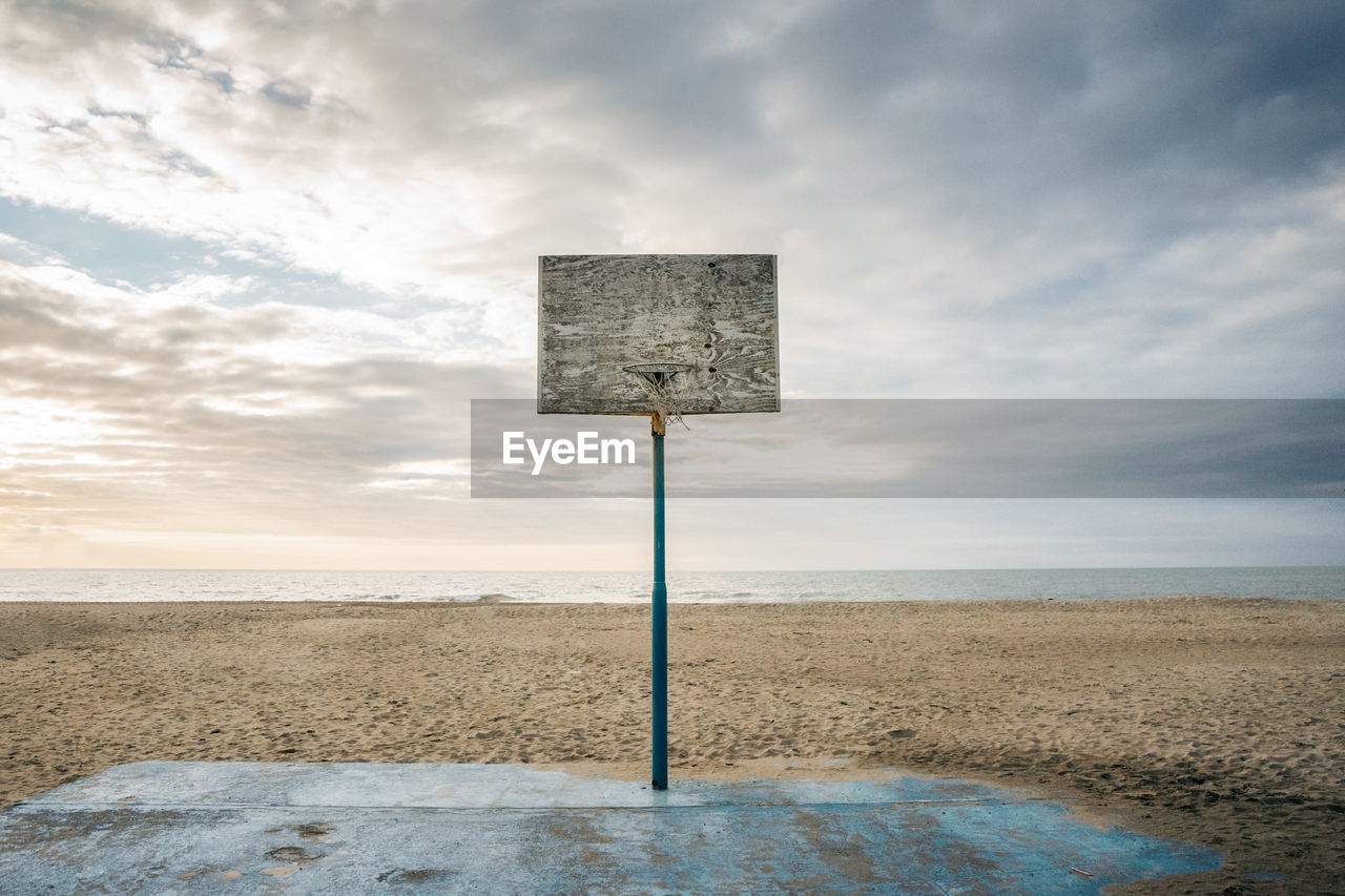 Basket on beach against sky