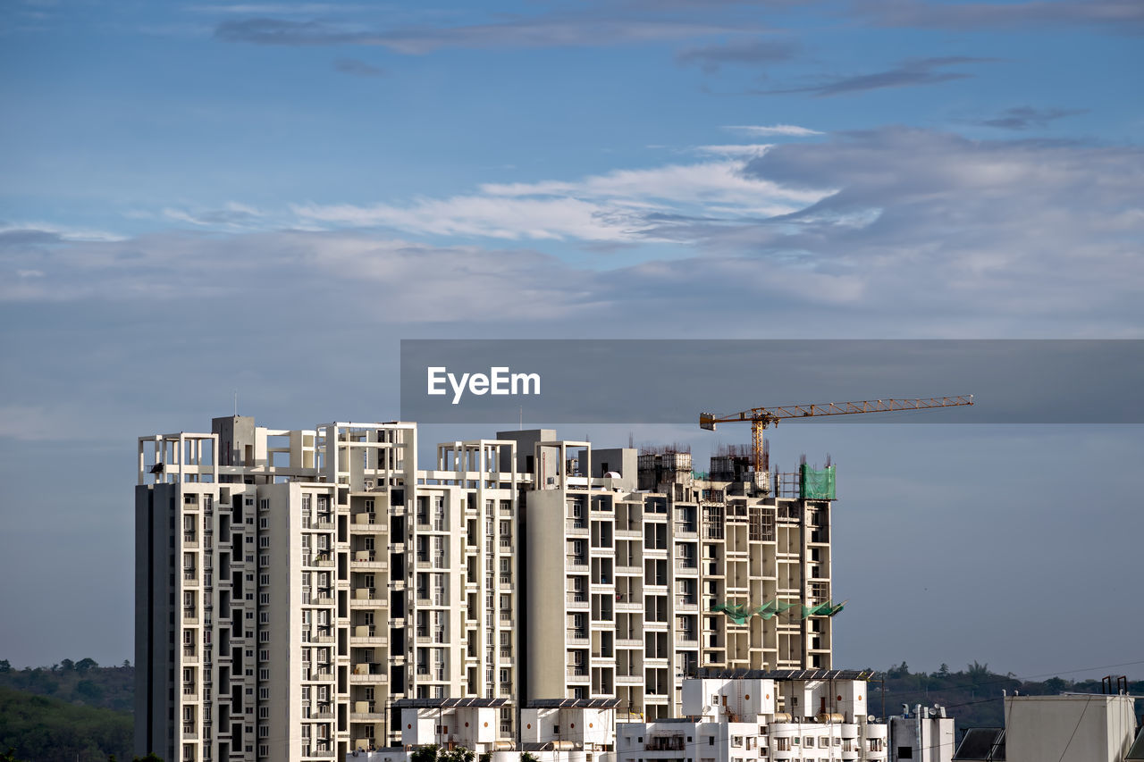 Twin, tall buildings under construction in pune, maharashtra, india.