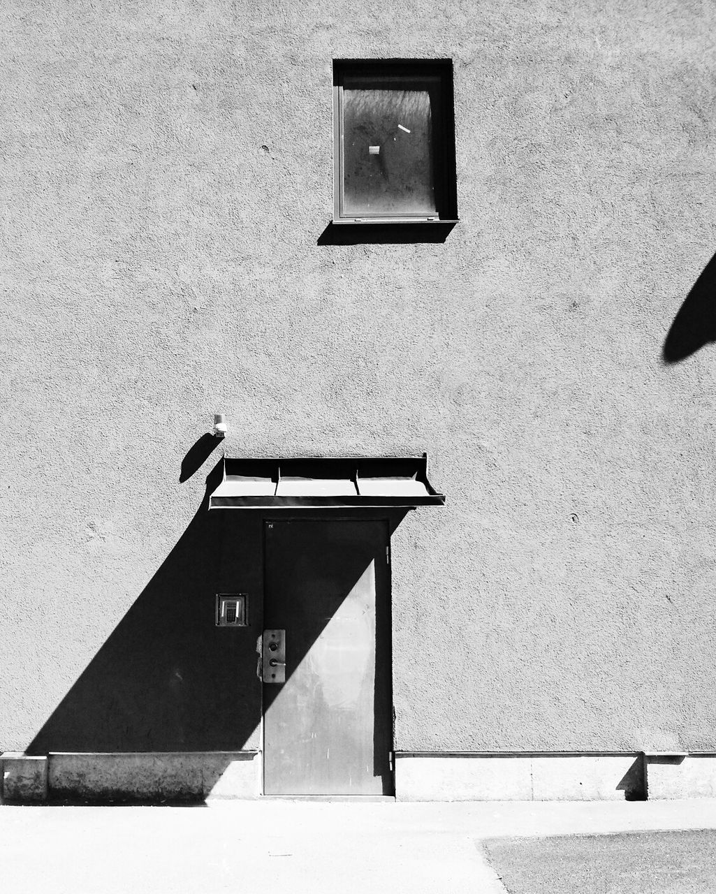 Awning shadow on wall of building