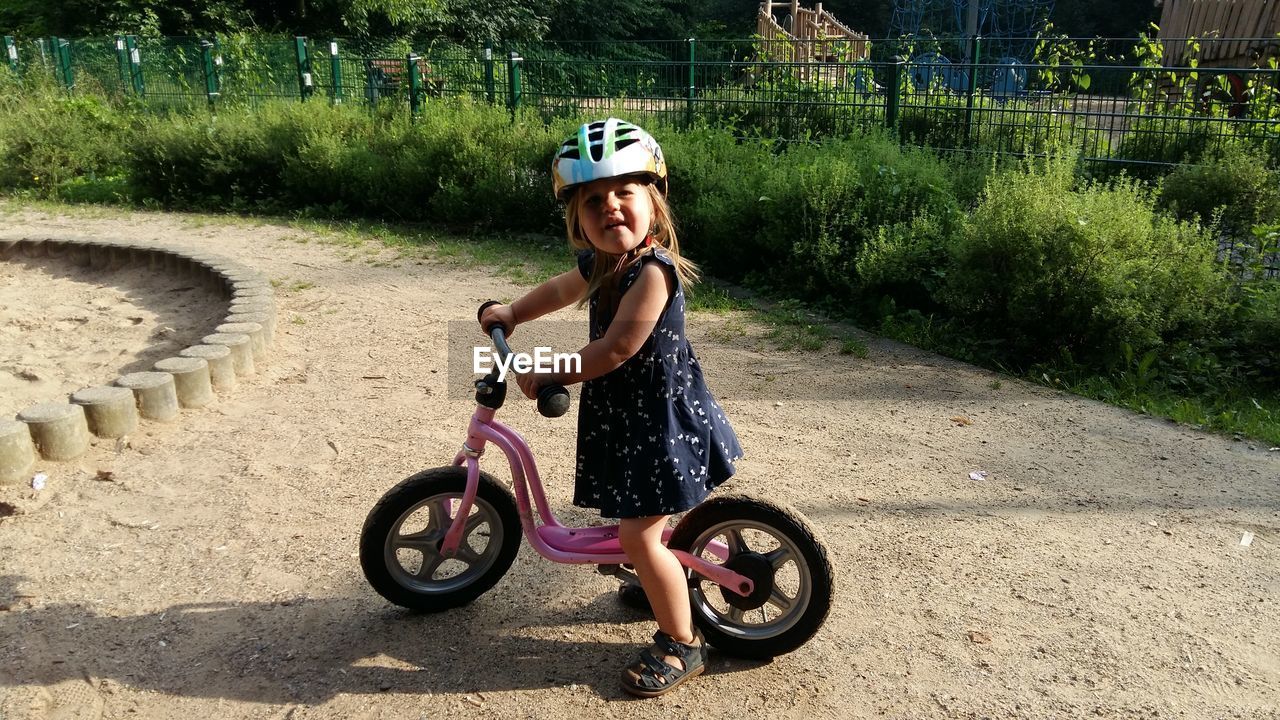 Portrait of girl riding bicycle outdoors