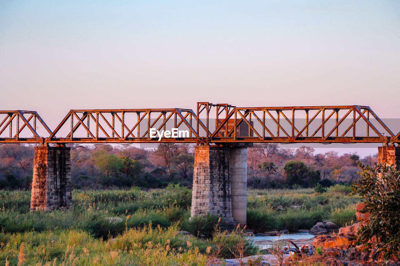 VIEW OF ABANDONED BRIDGE AGAINST SKY