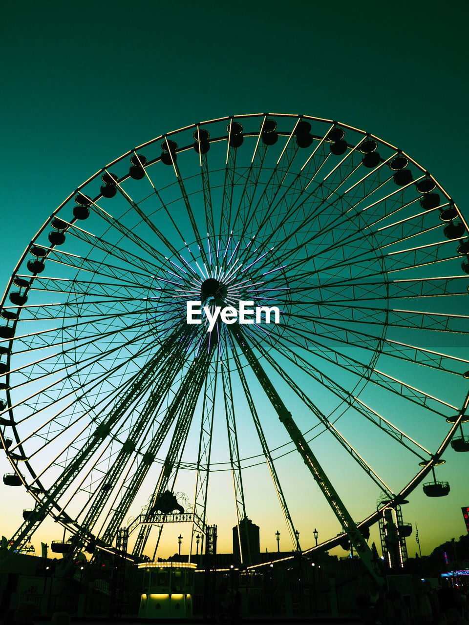 Low angle view of ferris wheel against sky