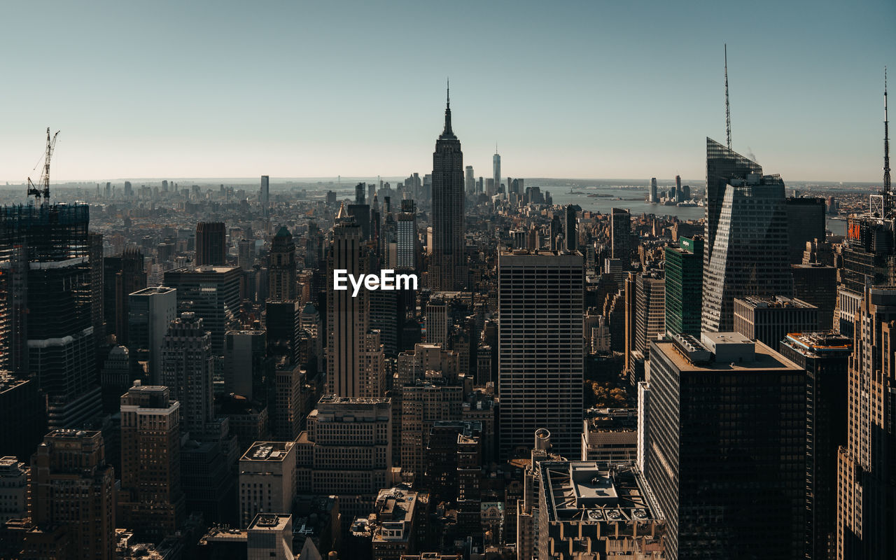 Empire statue building amidst cityscape