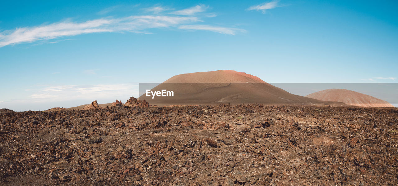 View of desert against cloudy sky