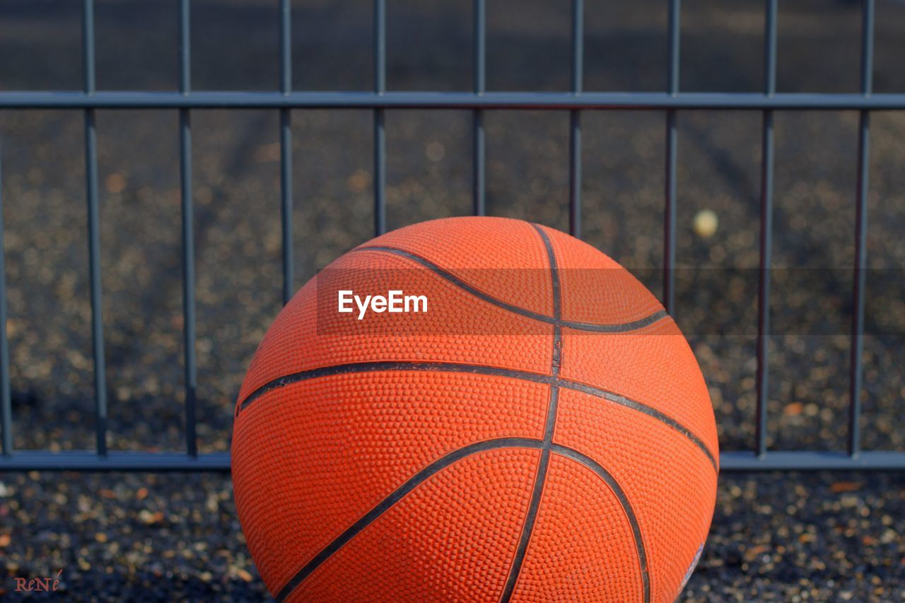 Close-up of basketball against fence